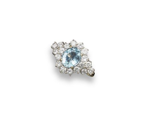 An aquamarine and diamond set cluster ring, the oval-shaped aquamarine is set within a surround of graduated round brilliant-