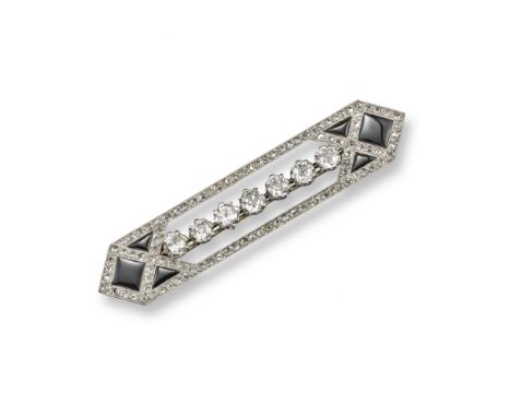 An Art Deco diamond and black onyx bar brooch, set with a line of seven cushion-shaped diamonds within the rose-cut diamond b