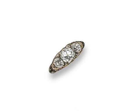 A late Victorian diamond three stone ring, the three principal cushion-shaped diamonds are set with six small rose-cut diamon