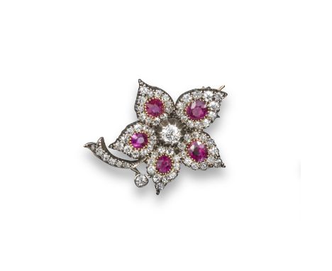 A late Victorian ruby and diamond foliate brooch, each petal set with an oval-shaped ruby within a surround of circular-cut d