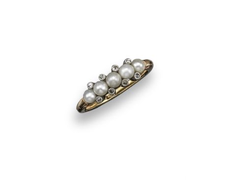 A gold half hoop ring, set with a line of five seed pearls and eight small diamonds. Scroll engraved shoulders. Size L ½.. 