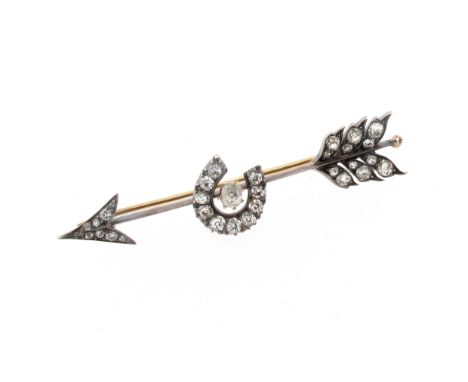 A late Victorian diamond-set arrow brooch, the realistically designed arrow with a horseshoe to the centre is set with old cu