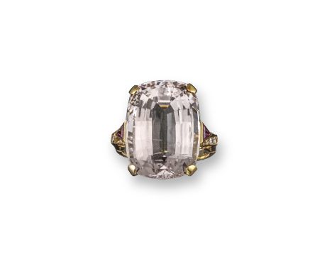 A morganite ring, the large cushion-shaped morganite is set with triangular-shaped rubies to the shoulders and single-cut dia