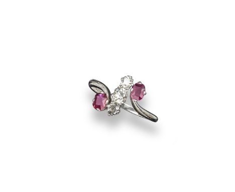 A diamond and ruby set crossover ring, set with two oval-shaped rubies and three cushion-shaped diamonds in platinum.