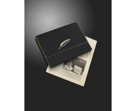 A black silk rectangular evening bag by Cartier, with gold coloured trim to the borders and applied with a gold feather, moun
