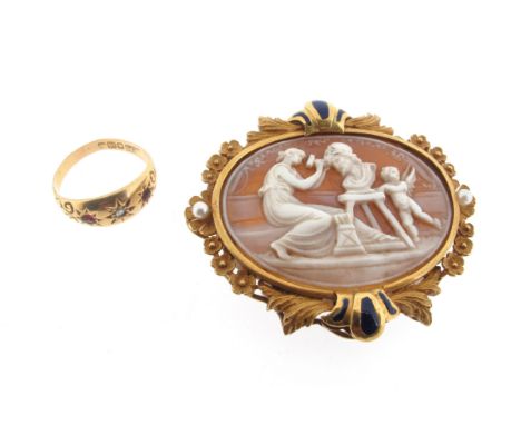 A late 19th century shell cameo brooch, depicting a seated woman carving a bust, with a putti, within ornately carved gold fr