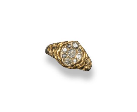 A diamond cluster ring, set with a cluster of old cushion-shaped diamonds in carved and pierced yellow gold mount. Stamped 18