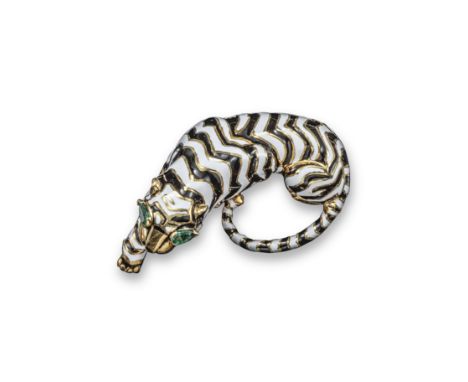 A gold and enamel tiger brooch by David Webb, stylistically designed with lines of white and black enamel and pear-shaped eme