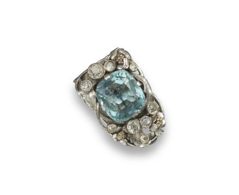 An aquamarine and diamond set Arts and Crafts style clip brooch, the cushion-shaped aquamarine is set within a surround of gr