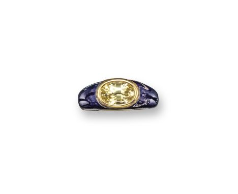 A yellow sapphire and blue enamel ring, the oval-shaped sapphire is set within a bombe blue enamel mount, in yellow gold. Mak