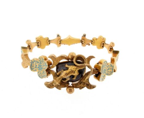 A late 19th century gold bracelet, the central panel is set with a garnet cabochon with a stylised gold lizard sitting on top