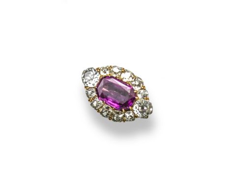 A ruby and diamond cluster ring, the cushion-shaped ruby is set within a surround of old cushion-shaped diamonds, and with a 