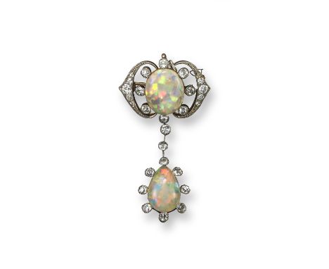 An Edwardian opal and diamond brooch pendant, the upper section set with an oval-shaped crystal opal with diamond set scroll 