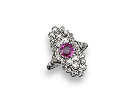 An Edwardian ruby and diamond oval-shaped cluster ring, the slightly oval-shaped ruby is set within a surround of graduated c