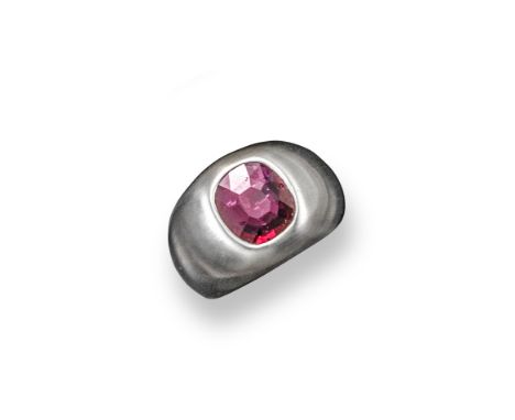 A ruby mounted white gold ring, the cushion shaped ruby is rub over set in a white gold gypsy ring with brushed finish. Size 