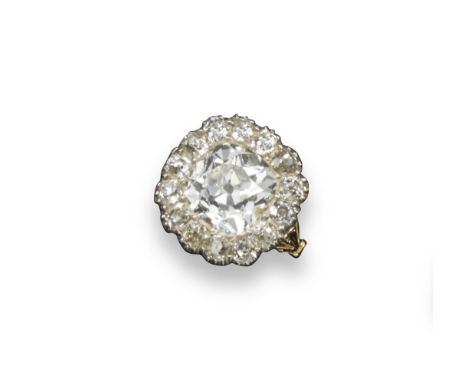 A diamond cluster ring, the centre cushion-shaped diamond weighs approximately 5.00cts and is set in a surround of fourteen s