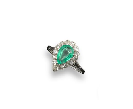 An emerald and diamond set cluster ring, the pear-shaped emerald is millegrain-set within a surround of cushion-shaped diamon