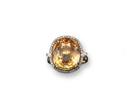 An unusual hessonite garnet and diamond set gold ring, the oval-shaped garnet weights approximately 15.14 cts and is set with