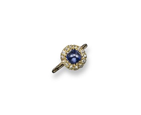 A sapphire and diamond cluster ring, the sugar-loaf sapphire is set within a surround of old cushion-shaped diamonds in yello