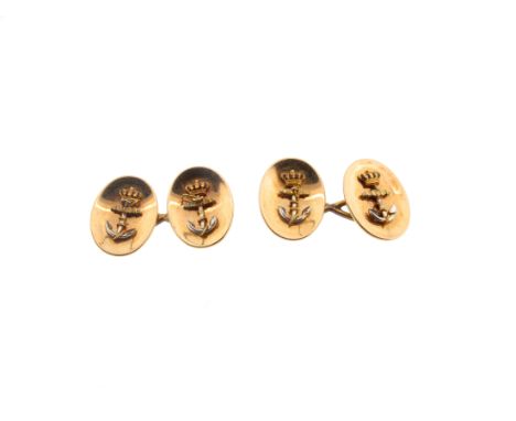 A pair of yellow gold Royal Navy cufflinks, each oval concave disc is applied with a crowned fouled anchor decorated with red