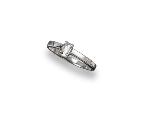 A diamond solitaire ring, the emerald-cut diamond is set in platinum. Size S 1/2.