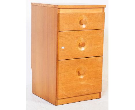 Meredew - A retro mid 20th century circa 1960s light oak pedestal chest / bedside cabinet,. The chest having a bank of three 