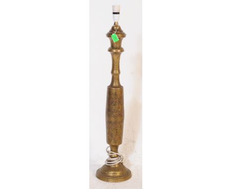 A vintage 20th century Indian brass column table light lamp. With light fixing to top, into a shaped central column on a circ