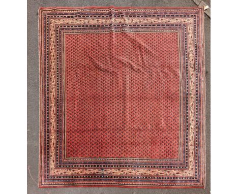 A 20th century north west Persian mir carpet floor rug. Having a red ground. With graduating borders surrounding a central se