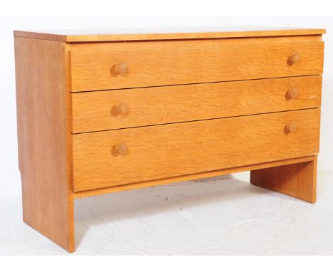 Meredew - A mid 20th century circa 1960s light oak chest of drawers. The chest of drawers having a bank of three drawers, eac
