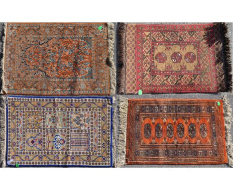 A collection of vintage 20th century Persian Islamic carpet floor rugs. To include a Belutch rug with repeating central medal