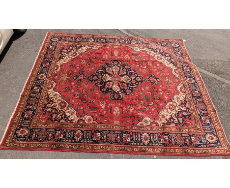 A vintage 20th century north west Persian Islamic Tabriz carpet floor rug. Having a central flora medallion, encapsulated in 