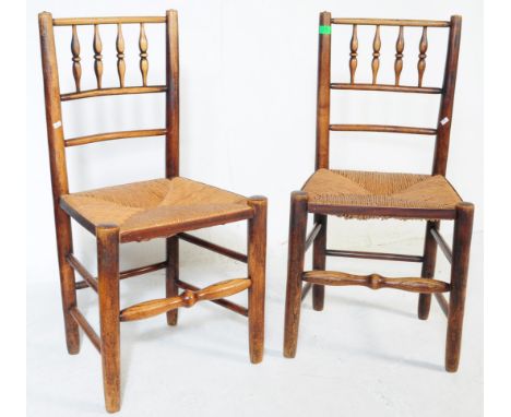 A pair of 18th century North Country elm wood Lancashire dining chairs. Raised on turned legs with peripheral stretchers havi