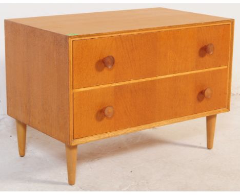 Meredew - A retro mid 20th century light oak Meredew low chest of drawers. The chest of drawers having a bank of twin drawers