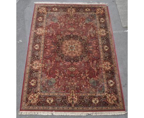 A large 20th century Persian Islamic Kashan carpet floor rug. Having a red ground, with large polychrome central floral medal