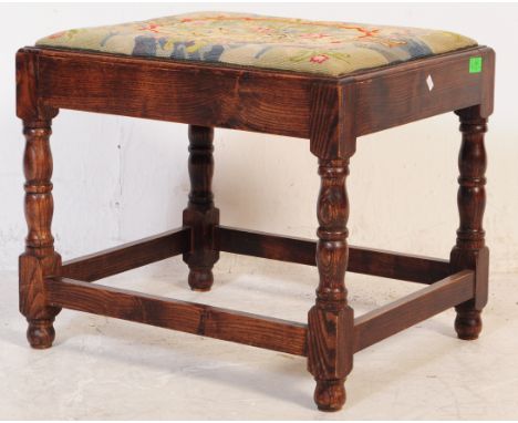 A 19th century oak and tapestry upholstered church footstool. The stool being raised on turned legs with peripheral stretcher