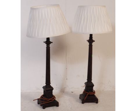 Pair of large oak early 20th century doric column lamp bases. Both with shades, central column on a tiered square base. Untes