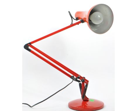 A mid 20th Century Anglepoise desk lamp in red colourway. The lamp with a rotating stem and shade, a push button switch atop 