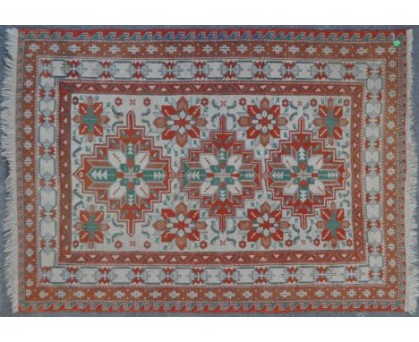 A mid 20th century vintage Persian Islamic Afghan Bazarak carpet floor rug. With three central medallions on a white panel su