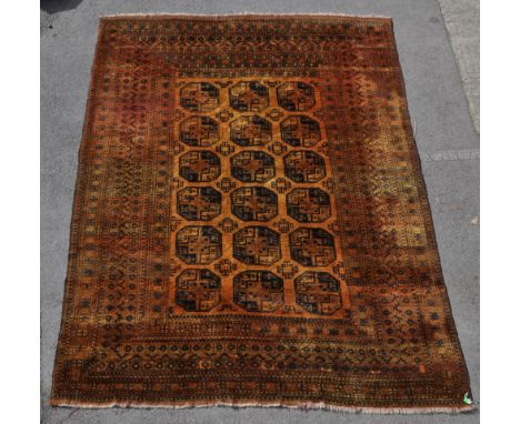 A 20th century Afghan Ersari village carpet floor rug. Having a golden ground, with dark blue patterning. Featuring repeating