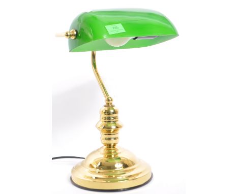 A vintage 20th Century bankers office table lamp light. Having a green glass swinging shade, with brass reeded support on a s