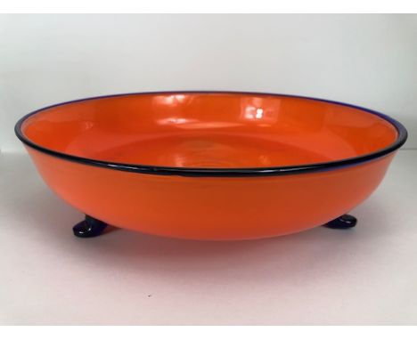 Studio art Glass, Lava Orange dish with blue rim supported on three blue legs, pontil mark to base, approximately 31cm diamet