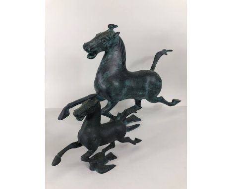 Oriental Art, two cast metal Tang Style horse sculptures, the larger approximately 33cm high, the smaller approximately 17cm 