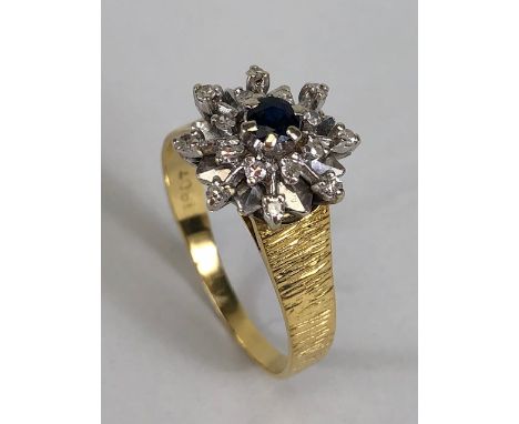 18ct Gold and Platinum set Daisy style ring with central Sapphire surrounded by diamonds approx size 'R' and 5.1g