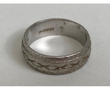 Platinum ring with all over engraved design approx size 'K' and 7g