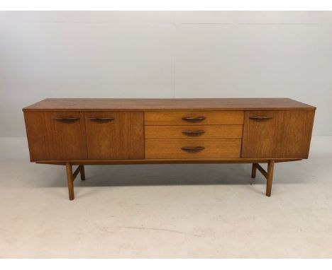 Mid-century teak sideboard by Avalon with three central drawers flanked by cupboards approx 204cm in length
