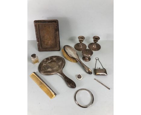 Good collection of antique silver items to include a wooden backed photo frame, pair of candle sticks, silver purse, bangle, 