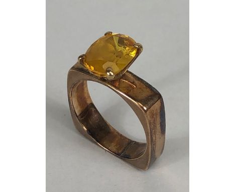 Antique and Vintage Jewellery, Mid Century design, square shank yellow metal ring set with an oval cut yellow stone approxima