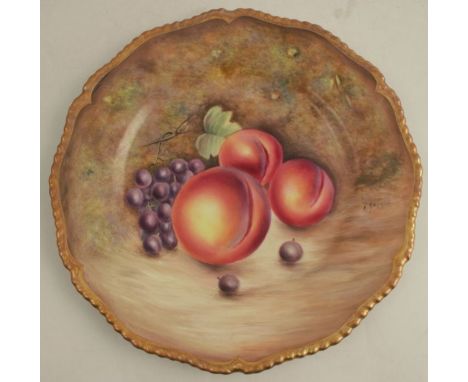 A Royal Worcester plate, with gadrooned border, decorated with hand painted fruit by Badham, diameter 10.5ins