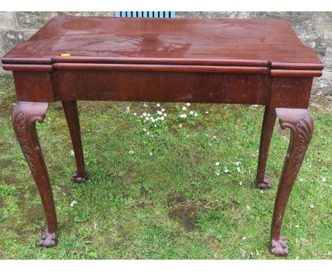 A Georgian design mahogany fold over card table, raised on cabriole legs, with claw and ball feet, width 35ins