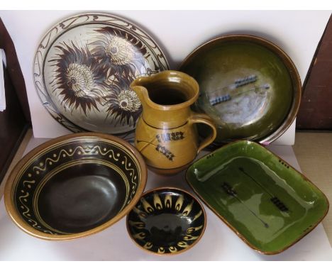 Six items of Winchcombe and other studio pottery, to include bowls, a jug, and a flowerhead decorated plate